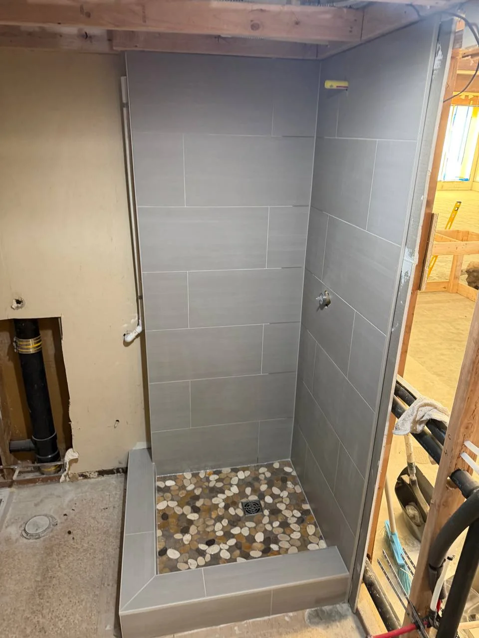 Gray Tile & River Rock Shower Base